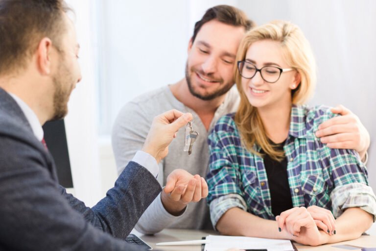 Manager giving key to couple